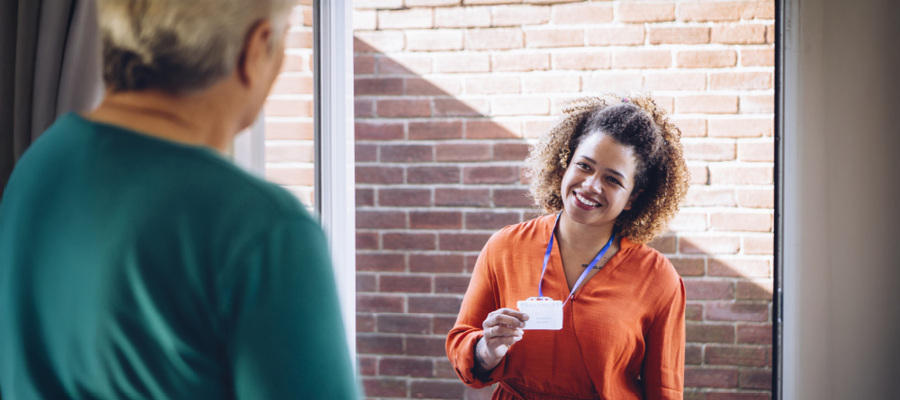 lady with id badge at a persons front door