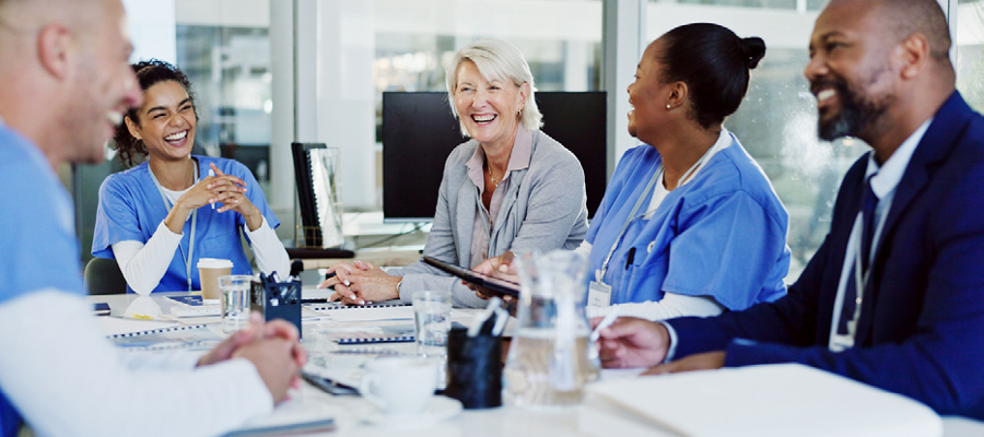 Men and women around a table representing council and medical meeting